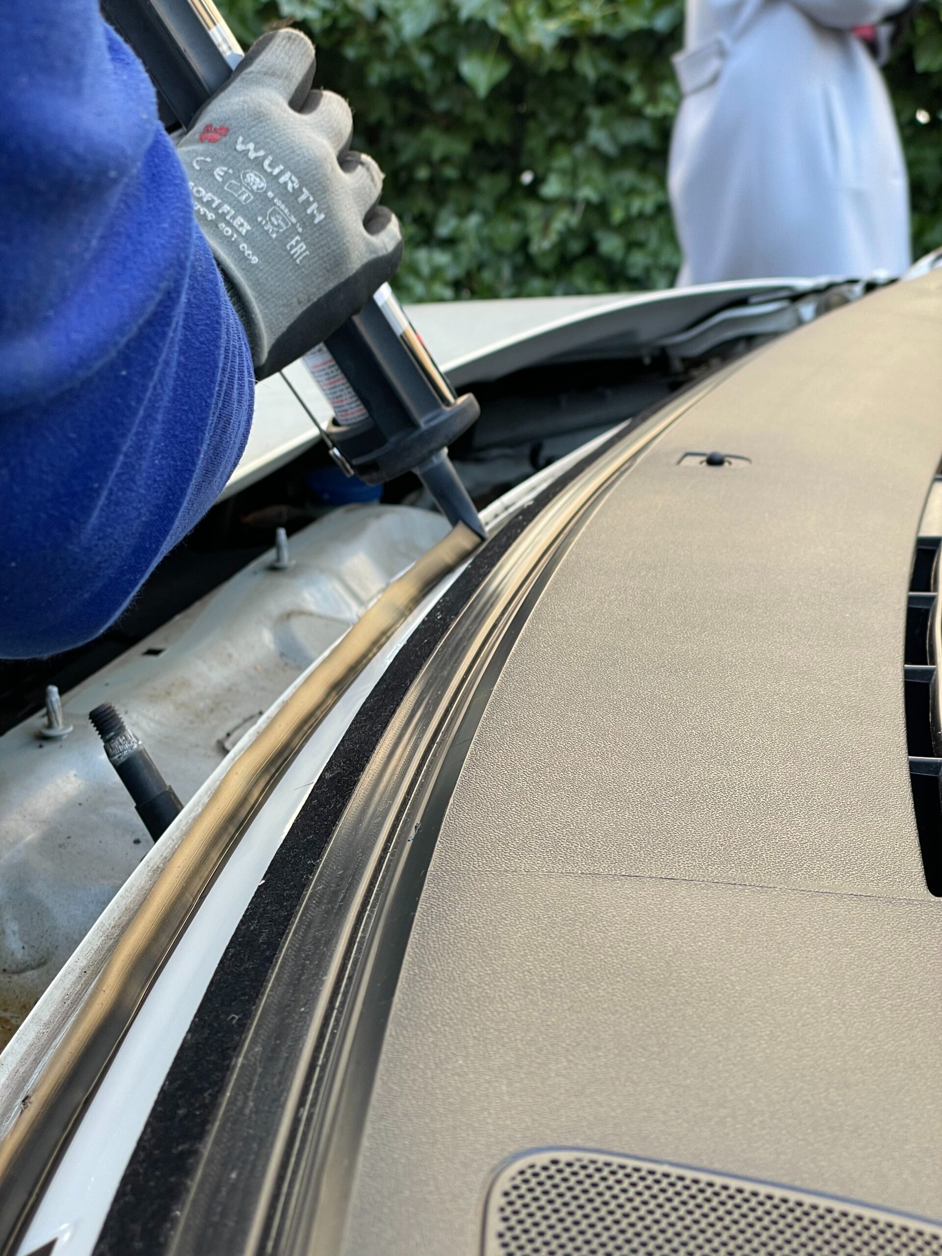 New windshield being set during a replacement